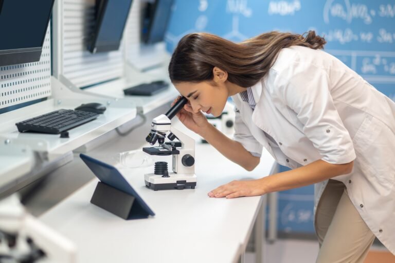 woman-leaning-microscope